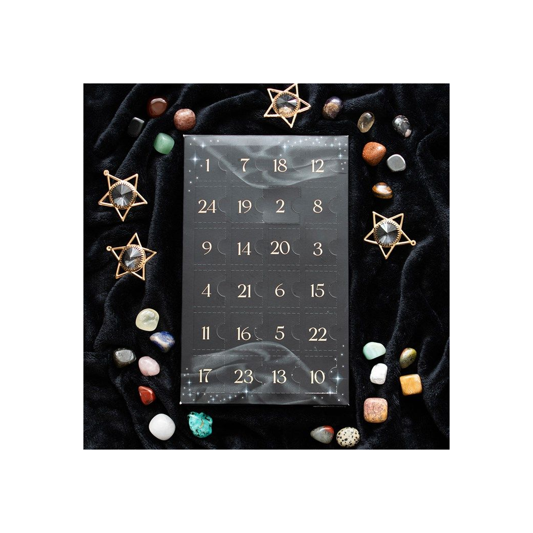 The calendar laying on black velvet with gems and crystals around it