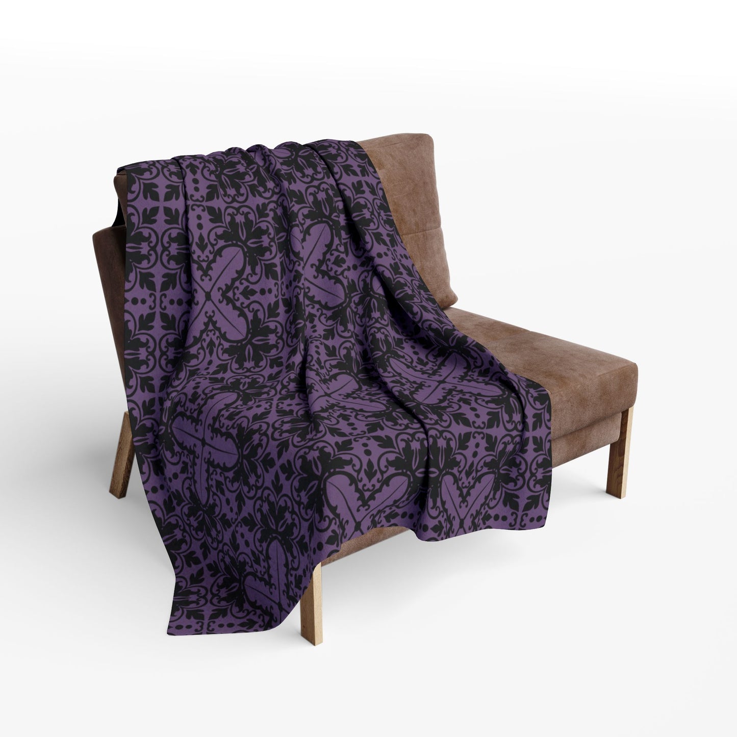 Purple blanket with a black damask pattern with gothic vibes draped over a chair