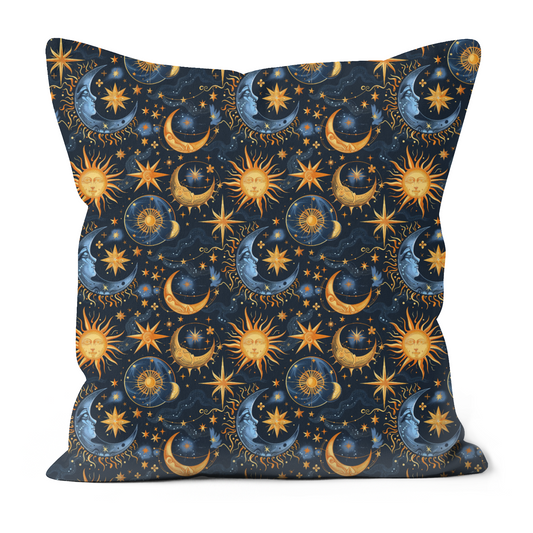 A dark blue pillow with vibrant gold and blue images of moons, the sun and stars