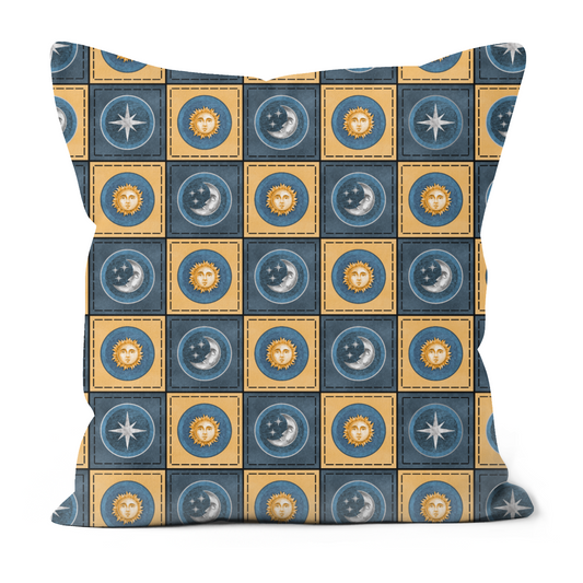 Patchwork effect blue and yellow cushion with sun, moon and stars on it.