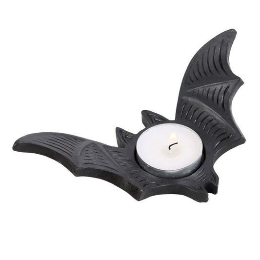 A tealight holder shaped like a bat containing a single tea light