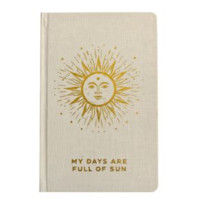 white gratitude journal with a golden sun on the front